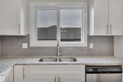 169 Robinson Drive, Leduc, AB - Indoor Photo Showing Kitchen With Double Sink With Upgraded Kitchen