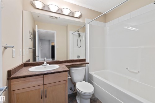 Bathroom featuring vanity and shower / washtub combination - 111 5951 165 Avenue, Edmonton, AB - Indoor Photo Showing Bathroom