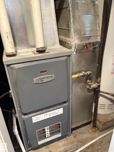 Utility room with heating unit - 4813 52 Avenue, Elk Point, AB - Indoor Photo Showing Basement