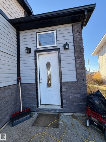 Entrance to property with stone siding - 4813 52 Avenue, Elk Point, AB - Outdoor With Exterior
