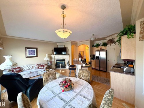 15 17603 99 Street, Edmonton, AB - Indoor Photo Showing Dining Room With Fireplace