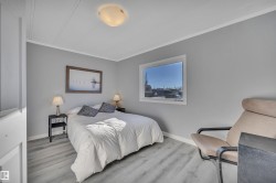 Bedroom with crown molding and wood finished floors - 