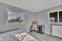 Bedroom with light wood-style floors and ornamental molding - 