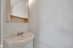 Bathroom with vanity and backsplash - 