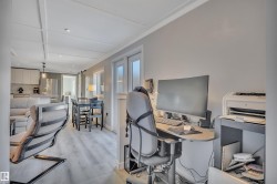 Office space featuring light wood-style flooring, recessed lighting, a barn door, and crown molding - 