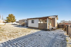 View of front facade with a fenced backyard and a deck - 