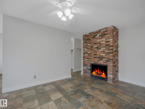 3 10836 116 Street, Edmonton, AB - Indoor Photo Showing Living Room With Fireplace