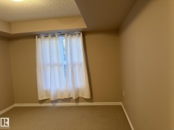Unfurnished room with carpet flooring and a textured ceiling - 
