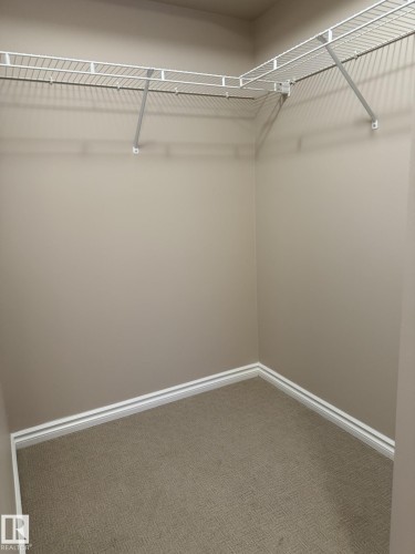 Walk in closet with carpet - 303 10118 106 Avenue, Edmonton, AB - Indoor With Storage