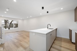 Laundry area featuring light wood finished floors and recessed lighting - 