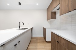 Laundry room with light wood-style floors and recessed lighting - 
