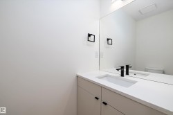 Half bathroom featuring vanity and toilet - 
