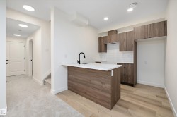 Kitchen with modern cabinets, brown cabinets, tasteful backsplash, a peninsula, and recessed lighting - 