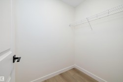 Spacious closet with light wood-style floors - 