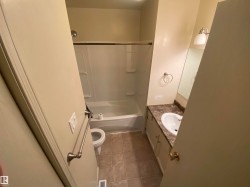 Bathroom featuring vanity, shower / washtub combination, and light tile patterned floors - 