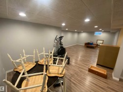 Workout area featuring a drop ceiling and recessed lighting - 