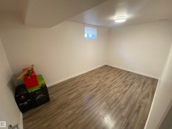 Basement featuring dark wood-style floors and baseboards - 