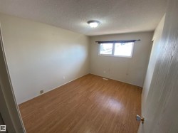 Spare room with light wood-style flooring and a textured ceiling - 