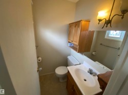Half bathroom featuring vanity and dark tile patterned floors - 