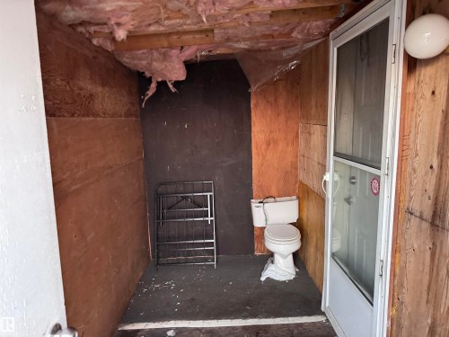 Full bath featuring toilet and bath / shower combo with glass door - 4748 50 St., Vimy, AB - Indoor