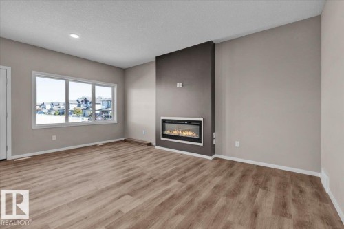 1152 South Creek Wynd, Stony Plain, AB - Indoor Photo Showing Living Room With Fireplace