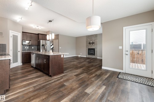 2211 Calhoun Link Link, Edmonton, AB - Indoor Photo Showing Kitchen With Fireplace With Upgraded Kitchen