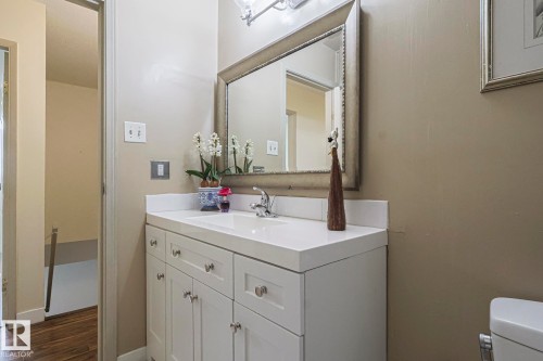 Half bathroom with vanity and dark wood-style floors - 51 Belmead Gardens, Edmonton, AB - Indoor Photo Showing Bathroom
