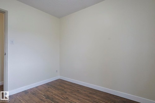 Spare room with dark wood-type flooring and a textured ceiling - 51 Belmead Gardens, Edmonton, AB - Indoor Photo Showing Other Room