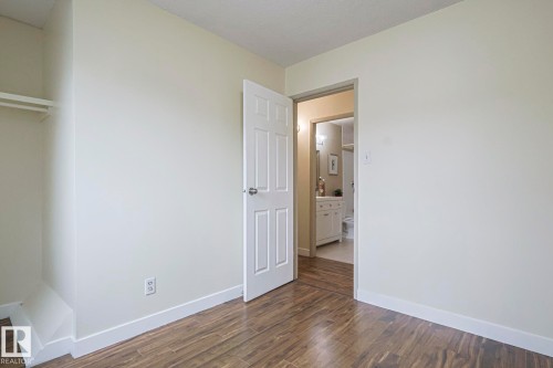 Unfurnished bedroom featuring baseboards and dark wood finished floors - 51 Belmead Gardens, Edmonton, AB - Indoor Photo Showing Other Room