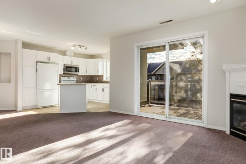 443 279 Suder Greens Drive, Edmonton, AB - Indoor Photo Showing Kitchen With Fireplace