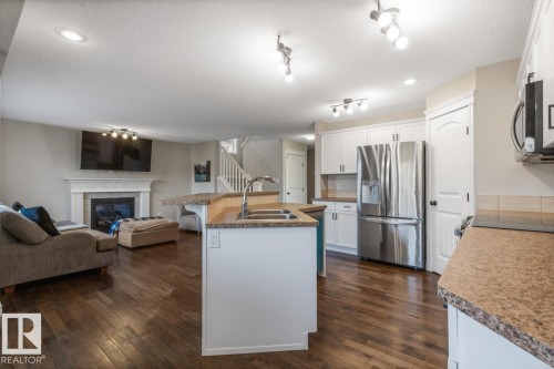 2 Sequoia Bend, Fort Saskatchewan, AB - Indoor Photo Showing Kitchen With Fireplace With Double Sink