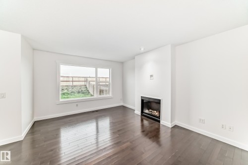 359 Simmonds Way, Leduc, AB - Indoor Photo Showing Other Room With Fireplace