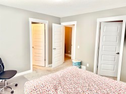 Bedroom featuring light carpet and a textured ceiling - 