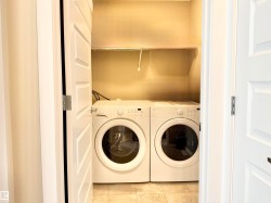 Laundry room featuring washer and dryer and tile patterned flooring - 