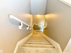 Staircase featuring carpet floors and baseboards - 