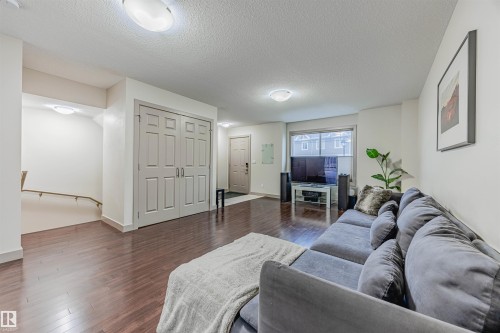 16 1150 Windermere Way, Edmonton, AB - Indoor Photo Showing Living Room With Fireplace