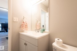 Half bathroom featuring vanity and wood finished floors - 