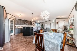 Dining room featuring a chandelier, dark wood-type flooring, and ornamental molding - 