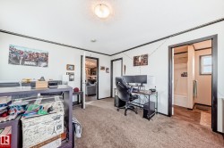 Carpeted bedroom with an office area - 