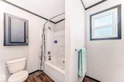 Bathroom featuring vanity, crown molding, dark wood-style flooring, and shower / bath combo - 