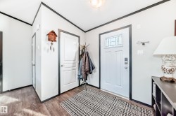 Foyer featuring wood finished floors and a textured ceiling - 