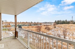 View of snow covered back of property - 