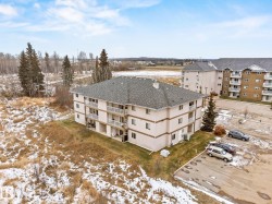 Snowy aerial view with a view of apartment building / complex - 