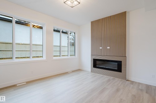 1568 Siskin Link, Edmonton, AB - Indoor Photo Showing Other Room With Fireplace