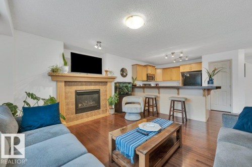 7620 11 Avenue, Edmonton, AB - Indoor Photo Showing Living Room With Fireplace
