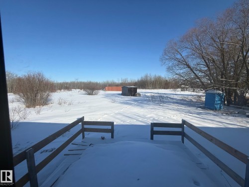 Expansive snow-covered outdoor area with a wooden fence in the foreground - 4904 51 Avenue, Opal, AB - Outdoor With View
