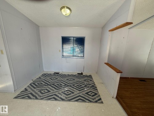 The interior space features light-colored walls, a window, and a ceiling-mounted light fixture - 4904 51 Avenue, Opal, AB - Indoor Photo Showing Other Room