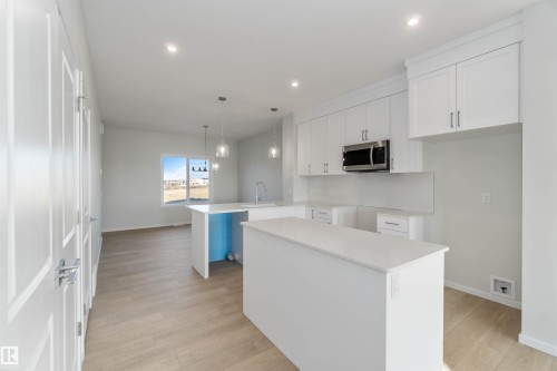 Kitchen featuring white cabinets, light wood-type flooring, a peninsula, hanging light fixtures, and recessed lighting - 262 Chappelle Drive, Edmonton, AB - Indoor Photo Showing Kitchen