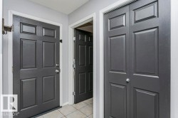 Entrance foyer featuring light tile patterned floors and baseboards - 