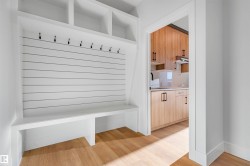Mudroom with light wood-style floors and a sink - 